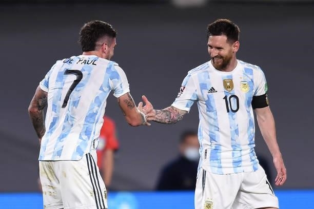 Rodrigo De Paul of Argentina celebrates with teammate Lionel Messi after scoring Rodrigo De Paul of Argentina during a match between Argentina and...