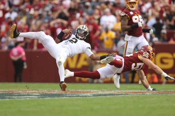 Jameis Winston of the New Orleans Saints is tackeld by Cole Holcomb of the Washington Football Team during the second half at FedExField on October...
