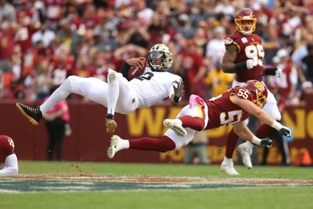 Jameis Winston of the New Orleans Saints is tackeld by Cole Holcomb of the Washington Football Team during the second half at FedExField on October...