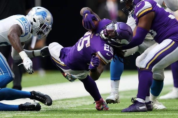 Alexander Mattison of the Minnesota Vikings spins back for the first down during the second half against the Detroit Lions at U.S. Bank Stadium on...