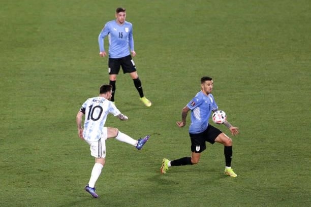 Lionel Messi of Argentina kicks the ball against Matias Vecino of Uruguay during a match between Argentina and Uruguay as part of South American...