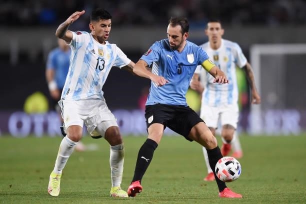 Cristian Romero of Argentina fights for the ball with Diego Godin of Uruguay during a match between Argentina and Uruguay as part of South American...