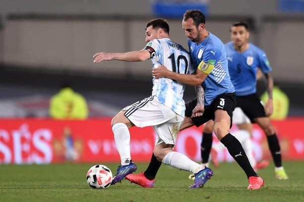 Lionel Messi of Argentina fights for the ball with Diego Godin of Uruguay during a match between Argentina and Uruguay as part of South American...