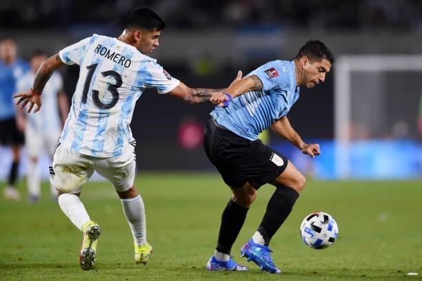 Luis Suarez of Uruguay fights for the ball with Cristian Romero of Argentina during a match between Argentina and Uruguay as part of South American...