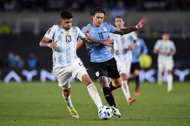 Darwin Núñez of Uruguay fights for the ball with Cristian Romero of Argentina during a match between Argentina and Uruguay as part of South American...