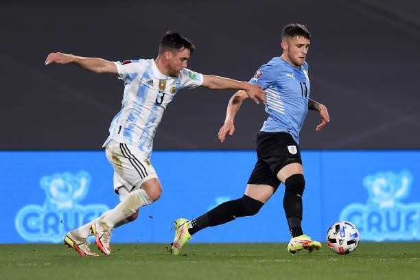 Giovanni Gonzalez of Uruguay fights for the ball with Nicolas Tagliafico of Argentina during a match between Argentina and Uruguay as part of South...