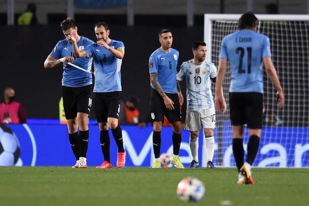 Lionel Messi of Argentina and Matias Vecino of Uruguay greet after a match between Argentina and Uruguay as part of South American Qualifiers for...