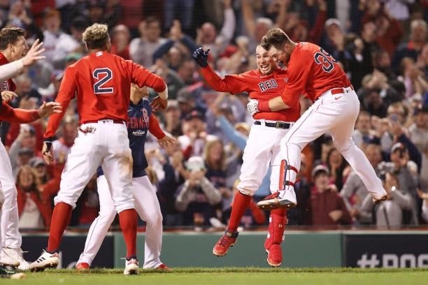 Christian Vazquez of the Boston Red Sox celebrates his game winning two-run homerun with teammates in the 13th inning against the Tampa Bay Rays...