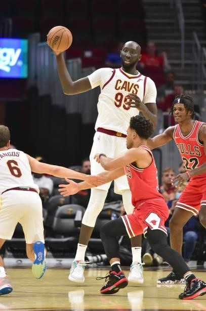 Tacko Fall tries to pass to Kevin Pangos # of the Cleveland Cavaliers while under pressure from Devon Dotson and Alize Johnson of the Chicago Bulls...