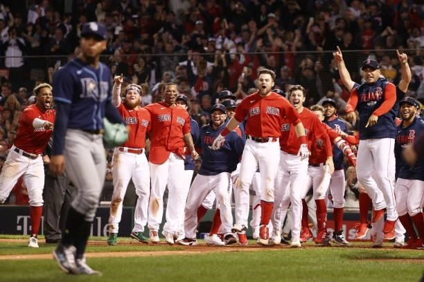 The Boston Red Sox celebrate their 6 to 4 win over the Tampa Bay Rays in the 13th inning during Game 3 of the American League Division Series at...