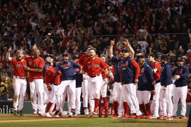 The Boston Red Sox celebrate their 6 to 4 win over the Tampa Bay Rays in the 13th inning during Game 3 of the American League Division Series at...