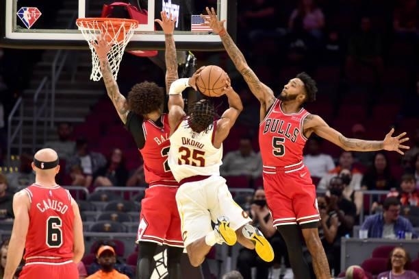 Isaac Okoro of the Cleveland Cavaliers shoots over Lonzo Ball and Derrick Jones Jr. #5 of the Chicago Bulls during the fourth quarter at Rocket...