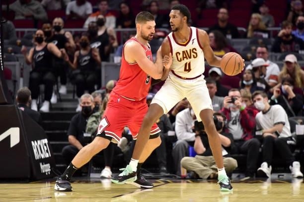 Nikola Vucevic of the Chicago Bulls guards Evan Mobley of the Cleveland Cavaliers during the fourth quarter at Rocket Mortgage Fieldhouse on October...