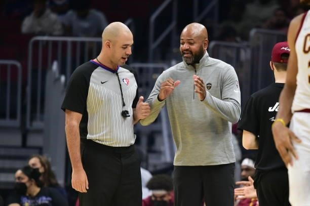 Referee Brandon Adair talks with head coach J.B. Bickerstaff of the Cleveland Cavaliers during the second quarter against the Chicago Bulls at Rocket...