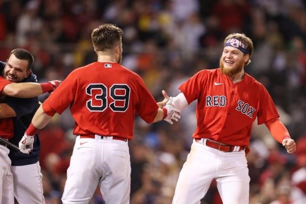 Christian Arroyo and Alex Verdugo of the Boston Red Sox celebrate their 6 to 4 win over the Tampa Bay Rays in the 13th inning during Game 3 of the...