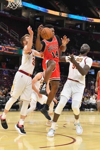 Dean Wade and Tacko Fall of the Cleveland Cavaliers double team Stanley Johnson of the Chicago Bulls during the fourth quarter at Rocket Mortgage...