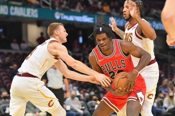 Alize Johnson of the Chicago Bulls fights for the ball with Dylan Windler and Lamar Stevens of the Cleveland Cavaliers during the third quarter at...
