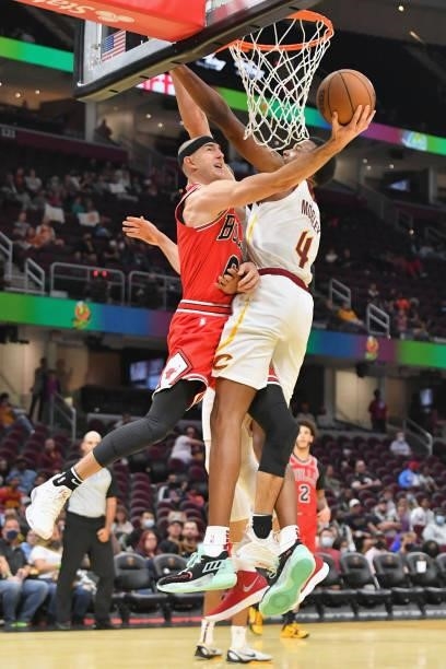 Alex Caruso of the Chicago Bulls tries to shoot around Evan Mobley of the Cleveland Cavaliers during the third quarter at Rocket Mortgage Fieldhouse...