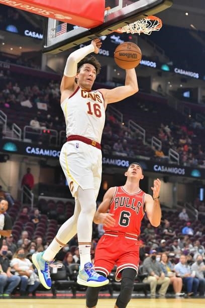 Cedi Osman of the Cleveland Cavaliers dunks over Alex Caruso of the Chicago Bulls during the second quarter at Rocket Mortgage Fieldhouse on October...