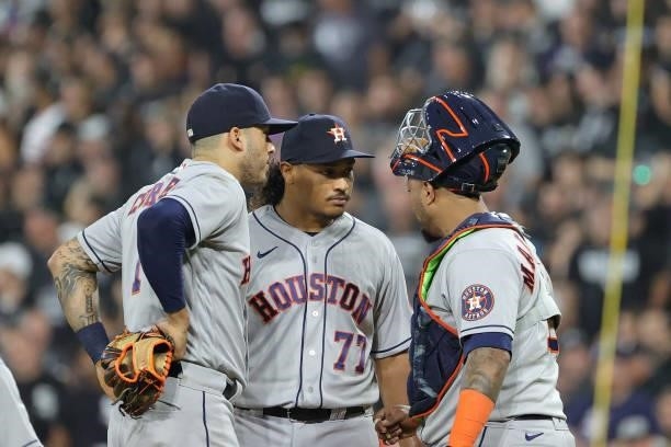 Luis Garcia of the Houston Astros speaks with Martin Maldonado and Carlos Correa of the Houston Astros in the third inning during game 3 of the...