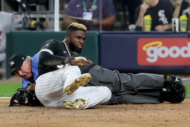 Luis Robert of the Chicago White Sox slides into home in the fourth inning during game 3 of the American League Division Series against the Houston...
