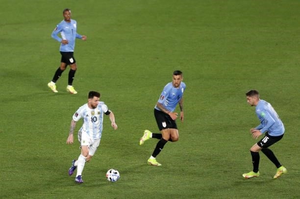 Lionel Messi of Argentina controls the ball against Matias Vecino of Uruguay during a match between Argentina and Uruguay as part of South American...
