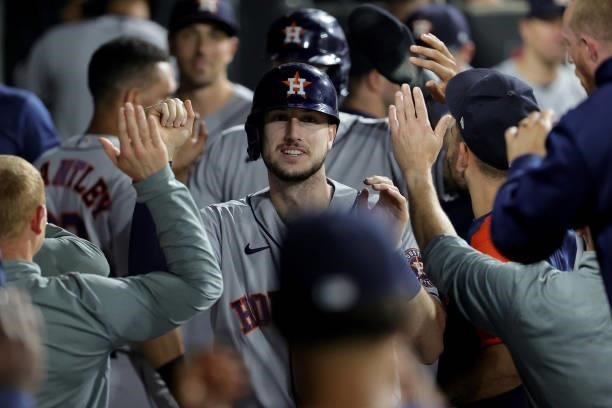 Kyle Tucker of the Houston Astros celebrates in the dugout with this teammates after hitting a home run in the third inning during game 3 of the...
