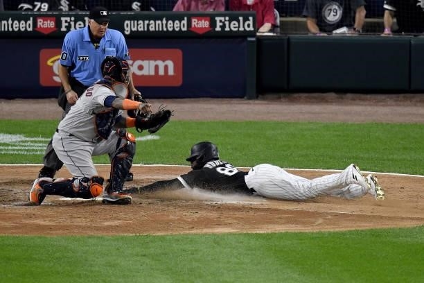 Luis Robert of the Chicago White Sox scores in the fourth inning during game 3 of the American League Division Series against the Houston Astros at...