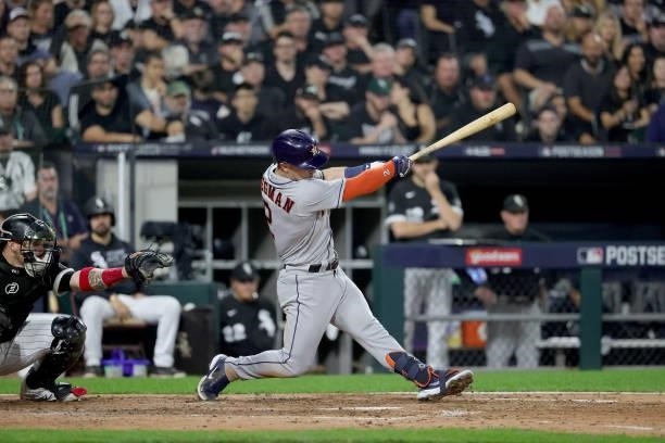 Alex Bregman of the Houston Astros hits a RBI single in the fourth inning during game 3 of the American League Division Series against the Chicago...