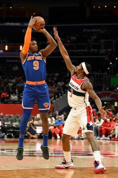 Barrett of the New York Knicks shoots the ball over Bradley Beal of the Washington Wizards at Capital One Arena on October 09, 2021 in Washington,...