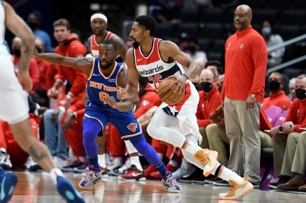 Spencer Dinwiddie of the Washington Wizards handles the ball against Kemba Walker of the New York Knicks at Capital One Arena on October 09, 2021 in...