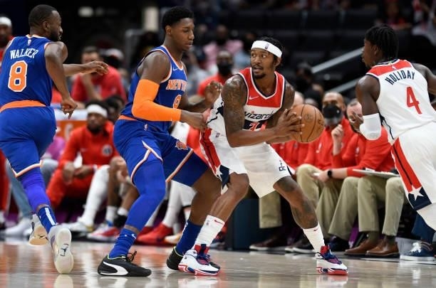 Bradley Beal of the Washington Wizards handles the ball against RJ Barrett of the New York Knicks at Capital One Arena on October 09, 2021 in...