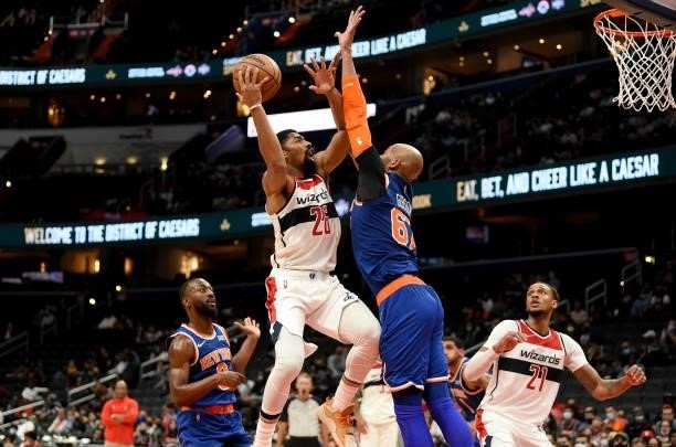 Spencer Dinwiddie of the Washington Wizards drives to the hoop in the second half against Taj Gibson of the New York Knicks at Capital One Arena on...