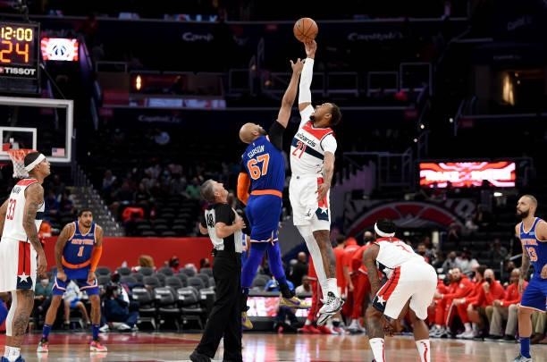 Taj Gibson of the New York Knicks jumps for the openig tip against Daniel Gafford of the Washington Wizards at Capital One Arena on October 09, 2021...