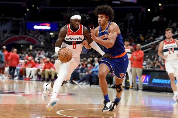 Montrezl Harrell of the Washington Wizards handles the ball against Jericho Sims of the New York Knicks at Capital One Arena on October 09, 2021 in...