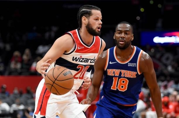 Jordan Schakel of the Washington Wizards handles the ball against Alec Burks of the New York Knicks at Capital One Arena on October 09, 2021 in...
