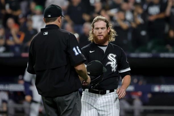 Craig Kimbrel of the Chicago White Sox has his glove inspected in the eighth inning during game 3 of the American League Division Series against the...