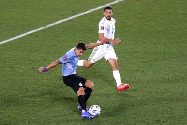 Luis Suarez of Uruguay kicks the ball against Lucas Martinez Quarta of Argentina during a match between Argentina and Uruguay as part of South...