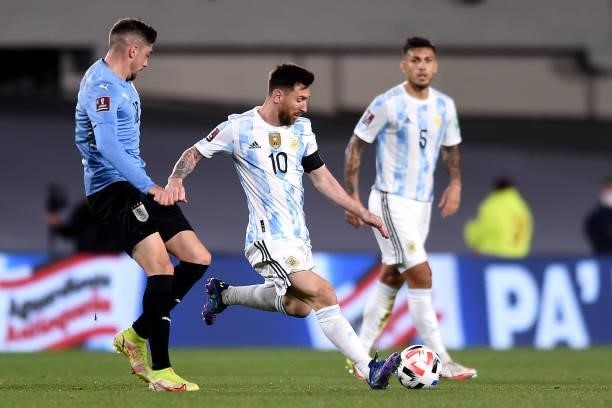 Lionel Messi of Argentina fights for the ball with Federico Valverde of Uruguay during a match between Argentina and Uruguay as part of South...