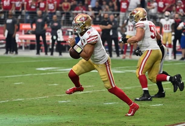 Trey Lance of the San Francisco 49ers runs with the ball against the Arizona Cardinals at State Farm Stadium on October 10, 2021 in Glendale, Arizona.