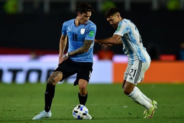 Darwin Nuñez of Uruguay controls the ball under pressure from Nahuel Molina of Argentina during a match between Argentina and Uruguay as part of...