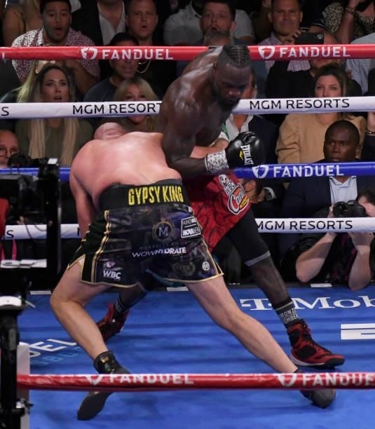 Tyson Fury falls to the floor as Deontay Wilder stands up during the World Heavyweight Championship III trilogy fight at T-Mobile Arena Saturday...