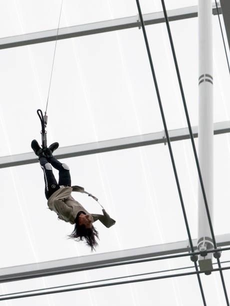 Illusionist Criss Angel escapes from a straitjacket while hanging above the field before a game between the Chicago Bears and the Las Vegas Raiders...