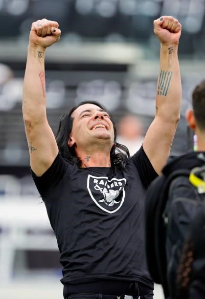 Illusionist Criss Angel reacts after escaping from a straitjacket while hanging above the field before a game between the Chicago Bears and the Las...