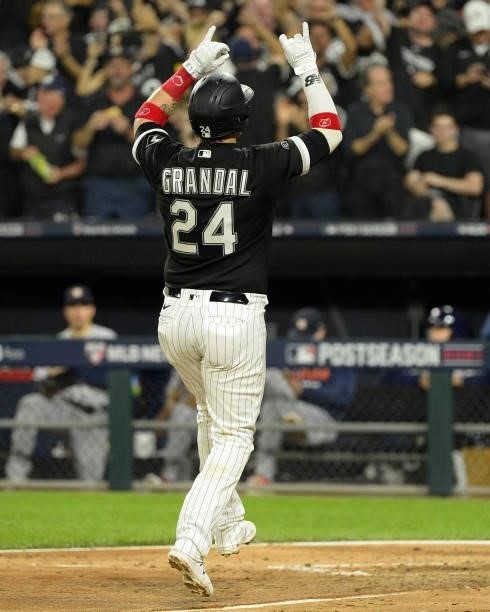 Yasmani Grandal of the Chicago White Sox reacts after hitting a two-run home run in the third inning during Game Three of the American League...