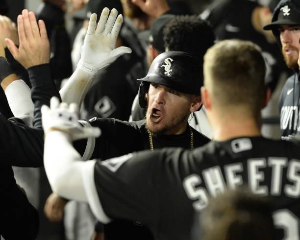 Yasmani Grandal of the Chicago White Sox celebrates with teammates after hitting a two-run home run in the third inning during Game Three of the...