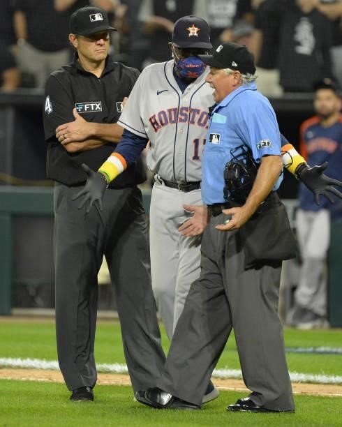 Manger Dusty Baker Jr. #12 of the Houston Astros agues with home plate umpire Tom Hallion in the fourth inning during Game Three of the American...
