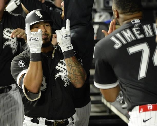Leury Garcia of the Chicago White Sox celebrates with teammates after hitting a three-run home run in the third inning during Game Three of the...
