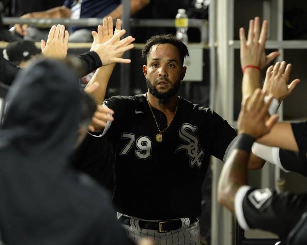 Jose Abreu of the Chicago White Sox celebrates with teammates after scoring a run in the fourth inning during Game Three of the American League...