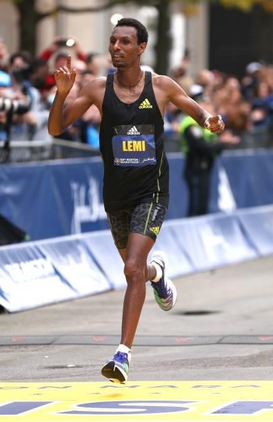 Lemi Berhanu of Ethiopia crosses the finish line for second place during the 125th Boston Marathon on October 11, 2021 in Boston, Massachusetts.